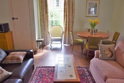 a living room with a couch and a table at The Stables in Carsethorn