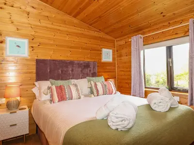 a bedroom with a bed with towels on it at Derwent Lodge in Keswick