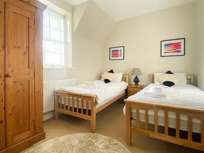 a bedroom with two beds and a window at The Court House - Uk43908 in Silloth