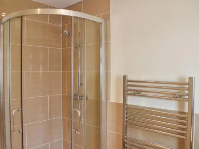 a shower with a glass door in a bathroom at The Court House - Uk43908 in Silloth