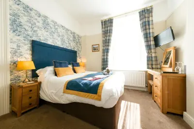 a bedroom with a large bed and a window at Avondale Guest House in Keswick
