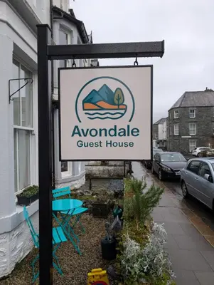 a sign for a guest house on a street at Avondale Guest House in Keswick
