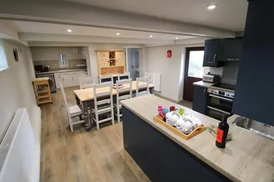 a kitchen and living room with a kitchen and a dining room at Brae Fell Cottage, Sebergham, Nr Caldbeck dog friendly and hot tub in Sebergham