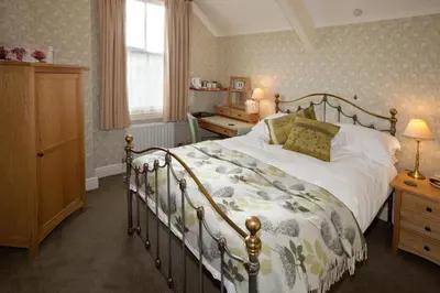 a bedroom with a large bed and a window at The Edwardene in Keswick