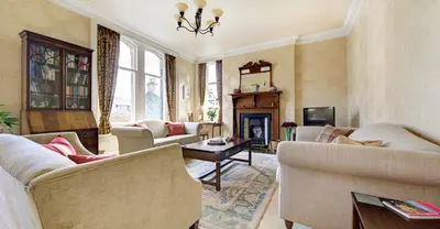 a living room with two couches and a fireplace at The Edwardene in Keswick