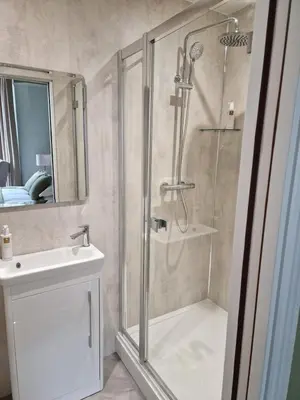 a bathroom with a shower and a sink at The Edwardene in Keswick