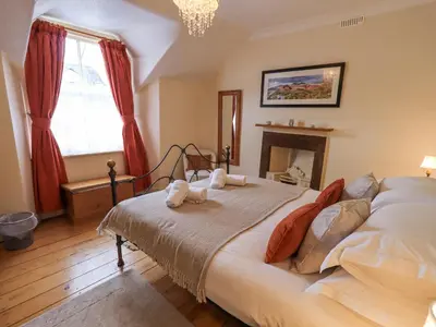 a bedroom with a bed with two towels on it at Primrose Cottage in Keswick