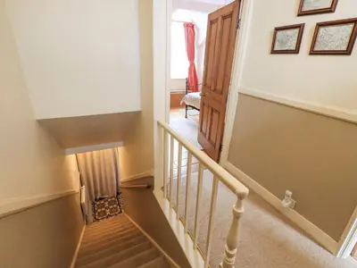 a staircase in a home with a stair case at Primrose Cottage in Keswick