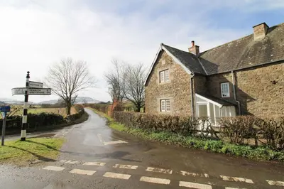 an old stone house on a road at Calley House, Hutton remote cottage with hot tub, 10 minutes to Ullswater in Penruddock
