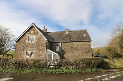 an old brick house with a car parked in front of it at Calley House, Hutton remote cottage with hot tub, 10 minutes to Ullswater in Penruddock