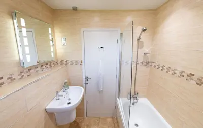 a bathroom with a sink and a toilet and a shower at Chapel Beck, Nr Caldbeck ideally family accommodation with hot tub in Sebergham