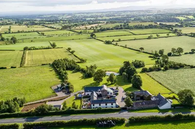 an aerial view of a house in the middle of a field at Fisher Gill, Sebergham, Close to Caldbeck Fells with hot tub in Sebergham
