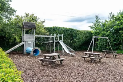 a playground with two benches and a slide at Fisher Gill, Sebergham, Close to Caldbeck Fells with hot tub in Sebergham