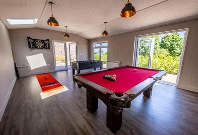 a billiard room with a red pool table at The Farmhouse, Sebergham, spacious family or group accommodation in a rural setting close to Caldbeck in Sebergham