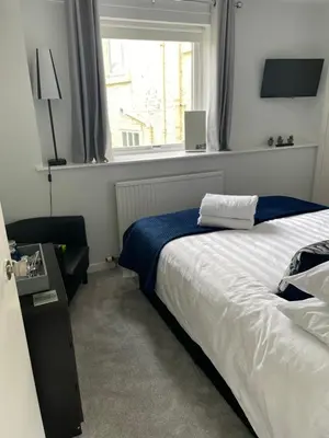 a bedroom with a large bed and a window at Little Limetree in Moffat