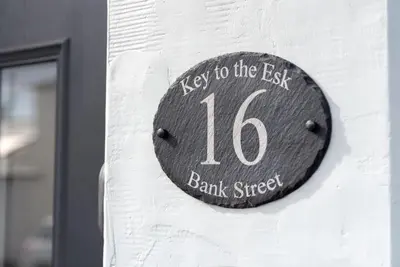 a wooden sign on the side of a building at Cottage - Sleeps 3 hot tub & pet friendly in Carlisle