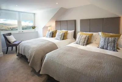 a bedroom with two beds and a window at Corriedow in Thornhill
