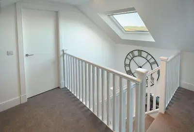a white staircase with a skylight in a house at Corriedow in Thornhill