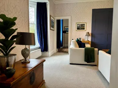 a living room with a couch and a table at Redwood Rise Apartment Keswick at The Lairbeck in Keswick