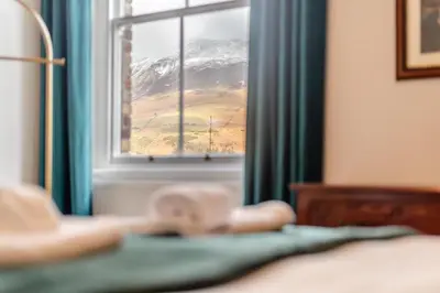 a window with a view of a snow covered mountain at Cameron Fell Apartment Keswick at The Lairbeck in Keswick