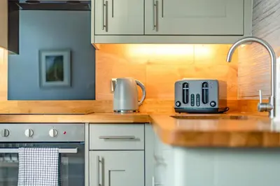 a kitchen counter with a toaster on a counter top at Bethby Beck Apartment Keswick at The Lairbeck in Keswick
