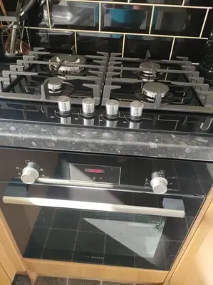 a stove top oven sitting in a kitchen at Family Home Near City Centre - New KING bed! in Carlisle