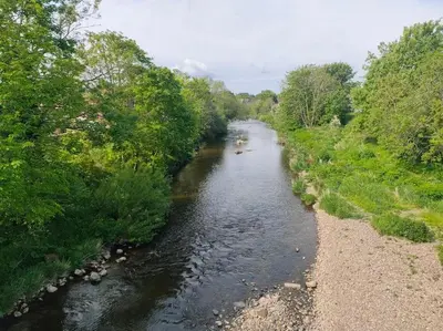 a river with several boats in it and trees at Family Home Near City Centre - New KING bed! in Carlisle