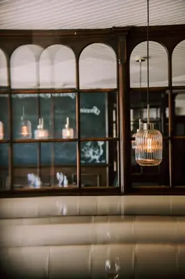 a chandelier is hanging in a room with windows at Allerdale Court Hotel in Cockermouth