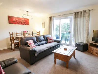 a living room with a couch and a table at Barley Cottage in Newton Stewart