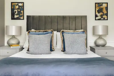 a bedroom with a bed with pillows and two lamps at Bellfoot Rural Retreat and Hot Tub in Grasmere