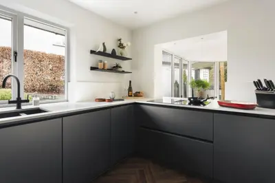 a kitchen with black cabinets and a window at Bellfoot Rural Retreat and Hot Tub in Grasmere
