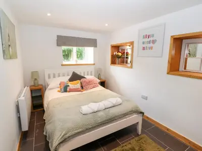 a bedroom with a bed and a window at Lands Brow Lodge in Red Dial