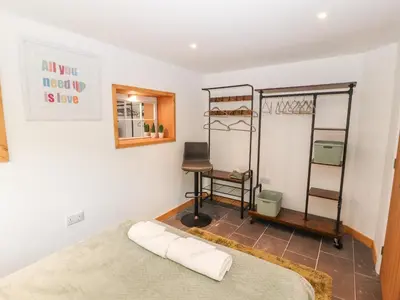 a bedroom with a bed and a desk at Lands Brow Lodge in Red Dial