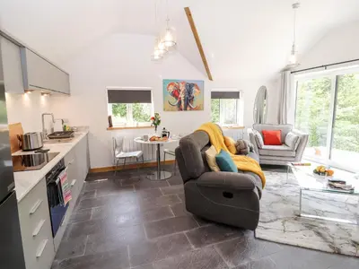 a living room with a couch and a table at Lands Brow Lodge in Red Dial