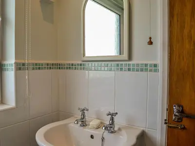 a bathroom with a sink and a window at Rivendell in Burgh by Sands