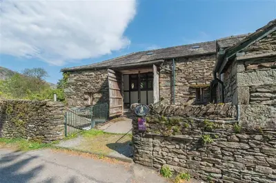 an old stone house with a stone wall at 2 Bed in Grasmere oc-gl007 in Grasmere