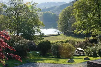 a garden with a view of a lake in the distance at 2 Bed in Grasmere oc-gl007 in Grasmere