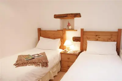 two beds sitting next to each other in a bedroom at 2 Bed in Grasmere oc-gl007 in Grasmere