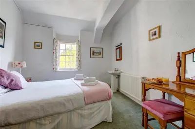 a bedroom with a bed and a desk and a window at 5 Bed in Grasmere oc-gl008 in Grasmere