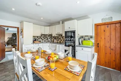 a kitchen with a wooden table with fruit on it at 3 Bed in Elterwater oc-gl011 in Chapel Stile