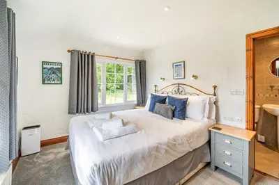 a bedroom with a large bed and a window at 3 Bed in Elterwater oc-gl011 in Chapel Stile