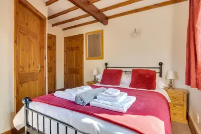 a bedroom with a bed with red and white towels on it at 2 Bed in Grasmere oc-gl081 in Grasmere