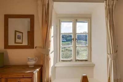 a room with a window and a table and a mirror at 3 Bed in Little Langdale oc-gl102 in Little Langdale