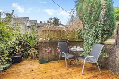 a patio with a table and chairs on a wooden deck at 2 Bed in Grasmere oc-ld175 in Grasmere