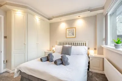 a bedroom with a white bed with two pillows on it at 2 Bed in Grasmere oc-ld175 in Grasmere