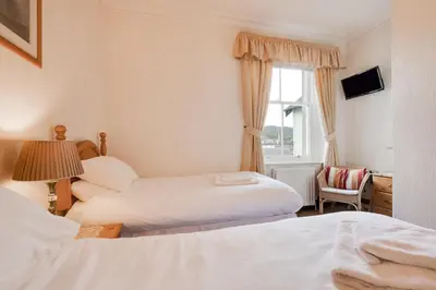 a hotel room with two beds and a window at 6 Bed in Keswick oc-ld177 in Keswick