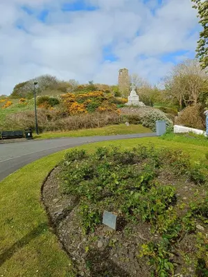a park with a road and a field of flowers at The Sunny Bunny Holiday Home in Ballantrae