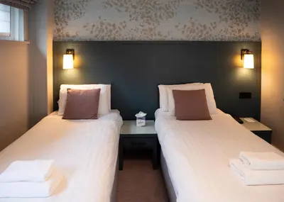 two beds sitting next to each other in a room at Gretna Hall Hotel in Gretna Green