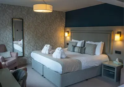 a bedroom with a large bed with towels on it at Gretna Hall Hotel in Gretna Green