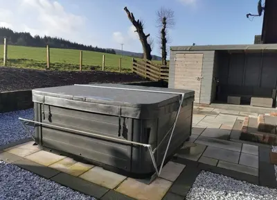 a metal container sitting on top of a patio at Cairnyard Lodges - Woodrow in Beeswing